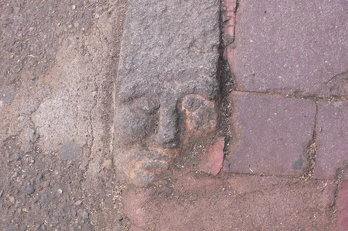 Carved kerb stones faces in Nuoro, Sardinia