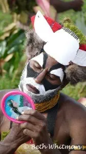 Man with mirror getting ready for Mt Hagen Show