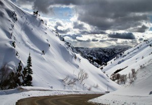 The beautiful mountain access road up to Powder Mountain with a skier skiing in the backcountry Photo: Stan Evans