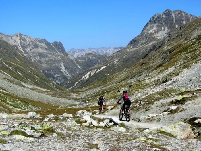 Bikers heading down the Suvretta Pass - hiking in St Moritz Engadin Switzerland Photo © 2018 • The Artful Passport