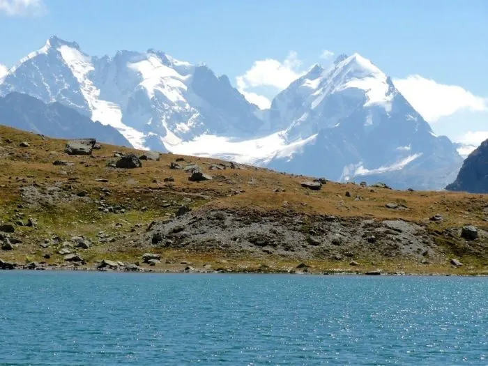 Snow capped mountains command the view from Lake Suvretta - hiking in St Moritz Engadin Switzerland Photo © 2018 • The Artful Passport